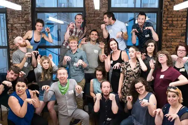 Group dressed casually making dinosaur poses and funny faces