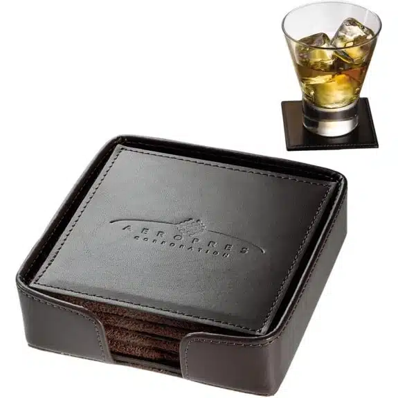 A picture of black leather coasters and a glass