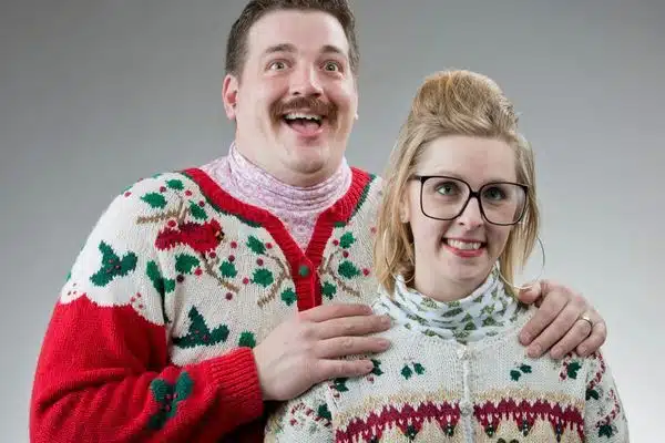 two people in ugly christmas sweaters
