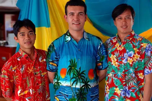 three men in hawaiin shirts