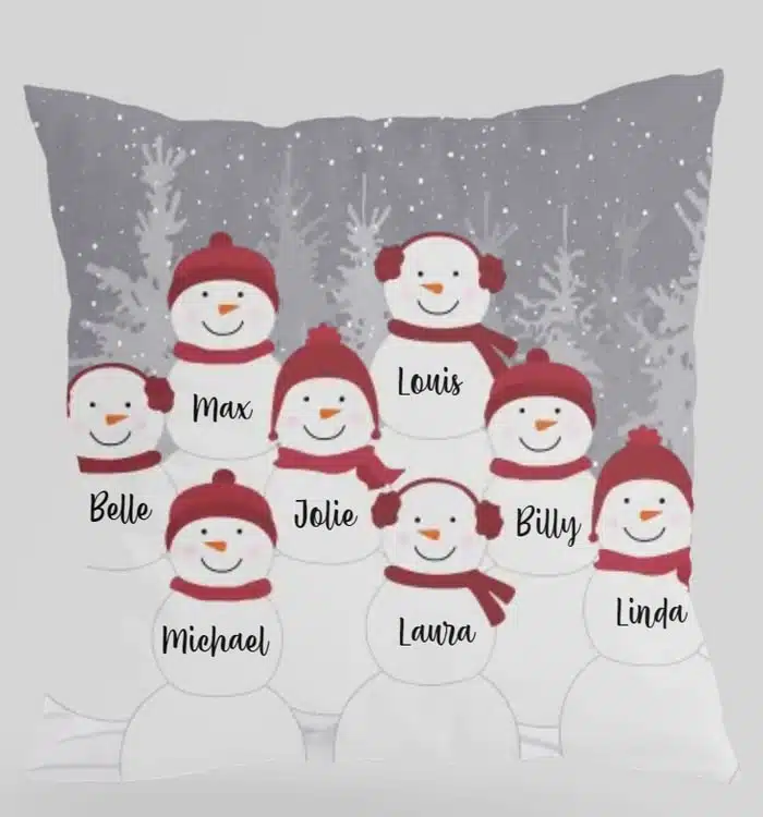 A picture of a throw pillow with snowmen on it