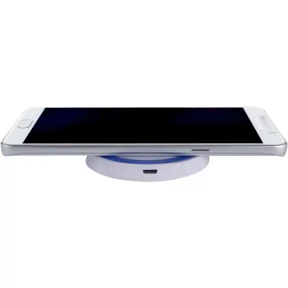 A picture of a white smartphone on a wireless charger